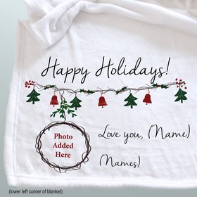 A personalized Christmas photo blanket personalized with the recipient and the gifter's names and photo.
